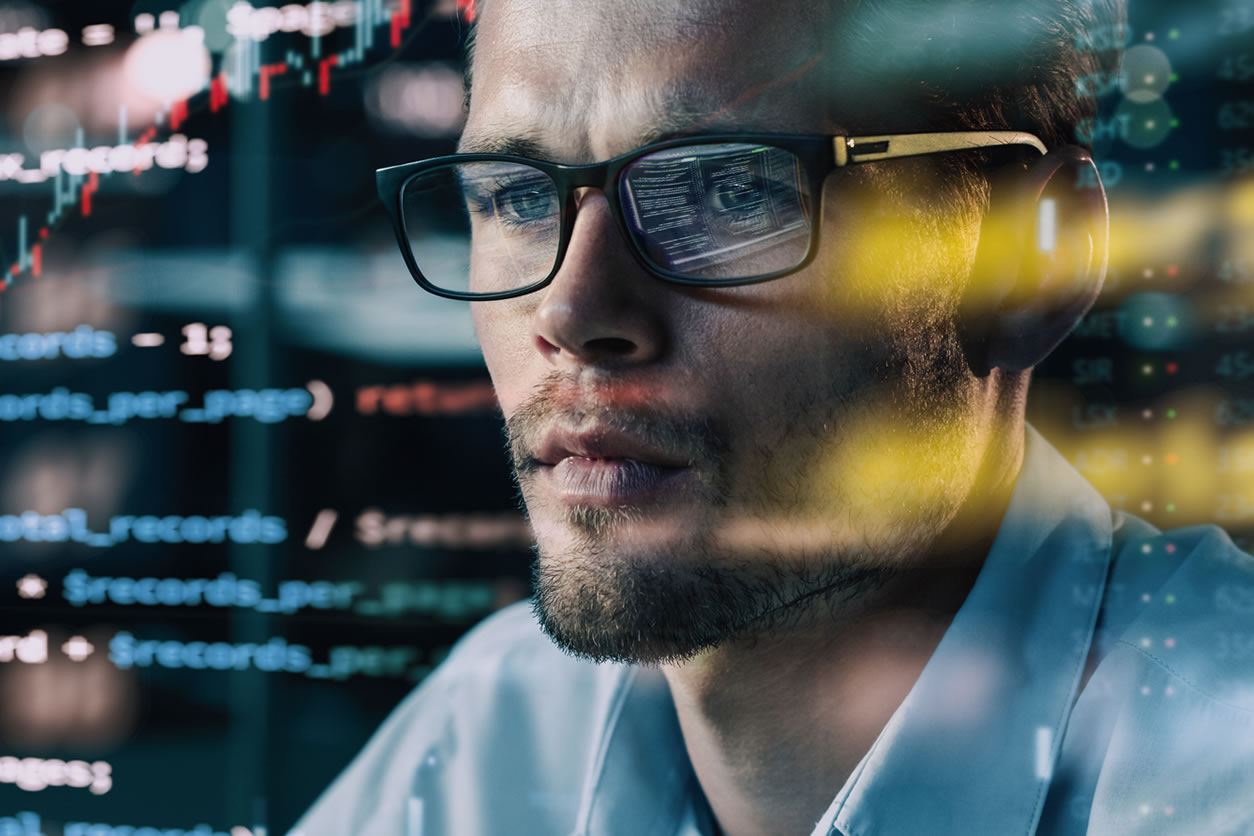 Picture of a software consultant looking at the code on the computer screen